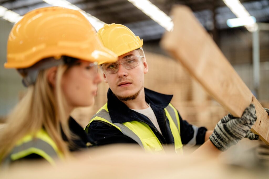 workers man and woman engineering walking and inspecting timbers